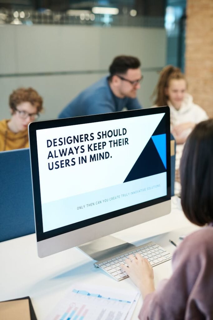 Crafting Captivating Headlines: Your awesome post title goes here Group of designers collaborating in modern office space with computer.